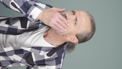 Vertical-video-of-Old-man-with-wrinkles-and-problems-on-his-skin-is-unhappy.